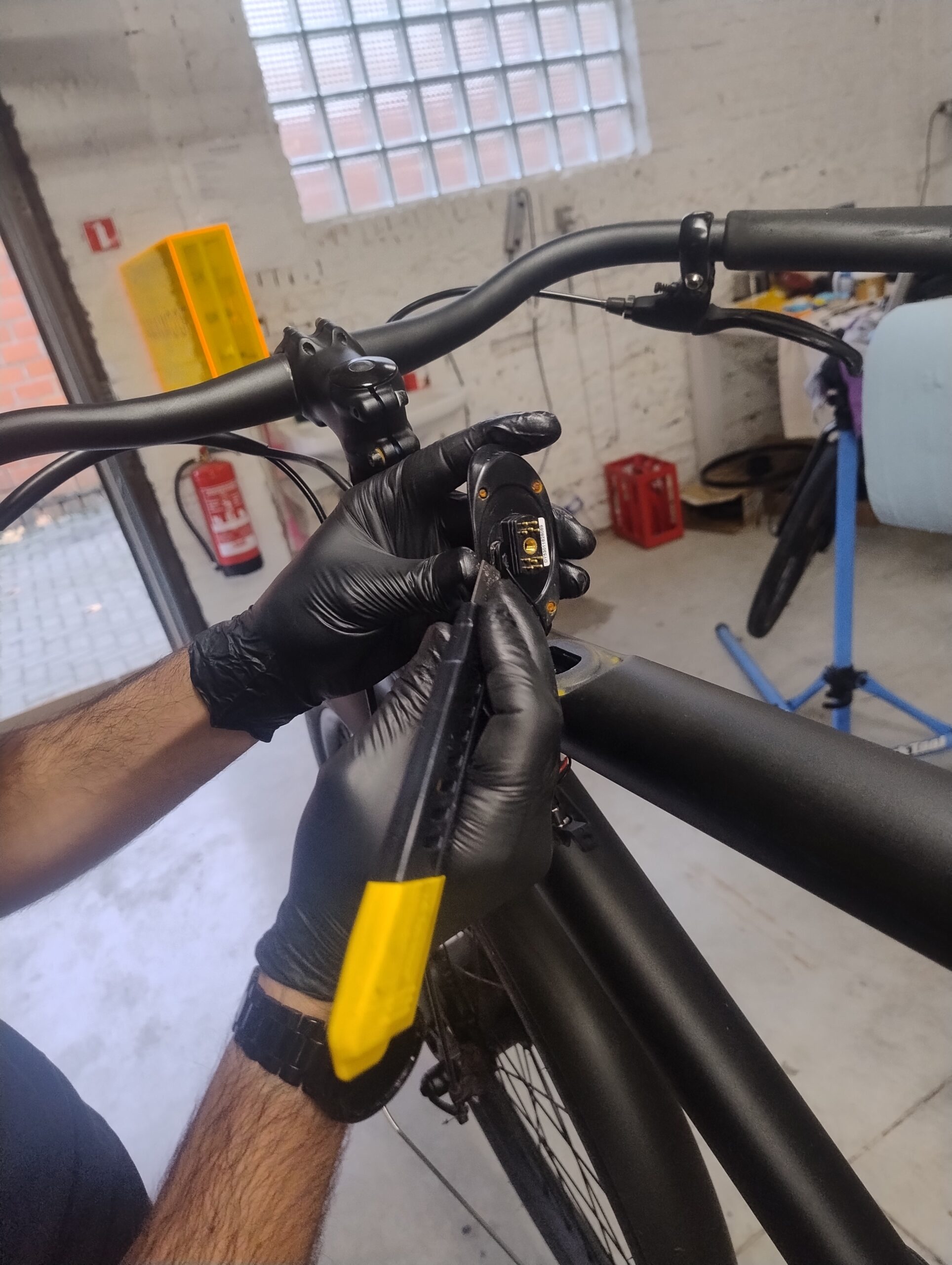 Hands repairing a VanMoof in the Lint workshop